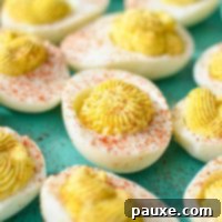 Effortless Instant Pot Deviled Eggs 11 A close up of deviled eggs, sprinkled with paprika.