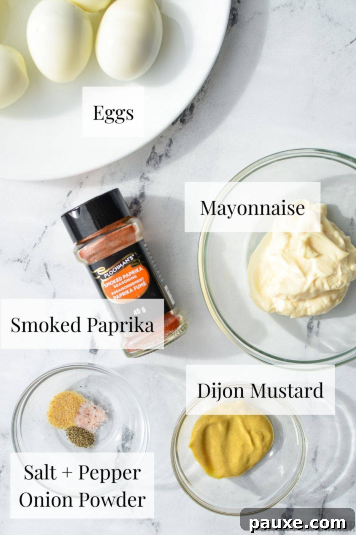 Effortless Instant Pot Deviled Eggs 3 The ingredients needed to make deviled eggs, including hard boiled eggs, mayonnaise, and paprika.