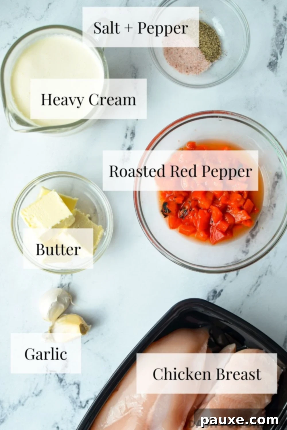 Velvety Roasted Red Pepper Chicken 3 A flat lay image displaying the five main ingredients for creamy red pepper chicken: chicken breasts, a jar of roasted red peppers, butter, heavy cream, and garlic cloves.