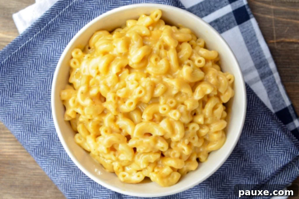 5-Ingredient Instant Pot Velveeta Mac and Cheese 10 A bowl of Instant Pot macaroni and cheese, on a blue napkin background.