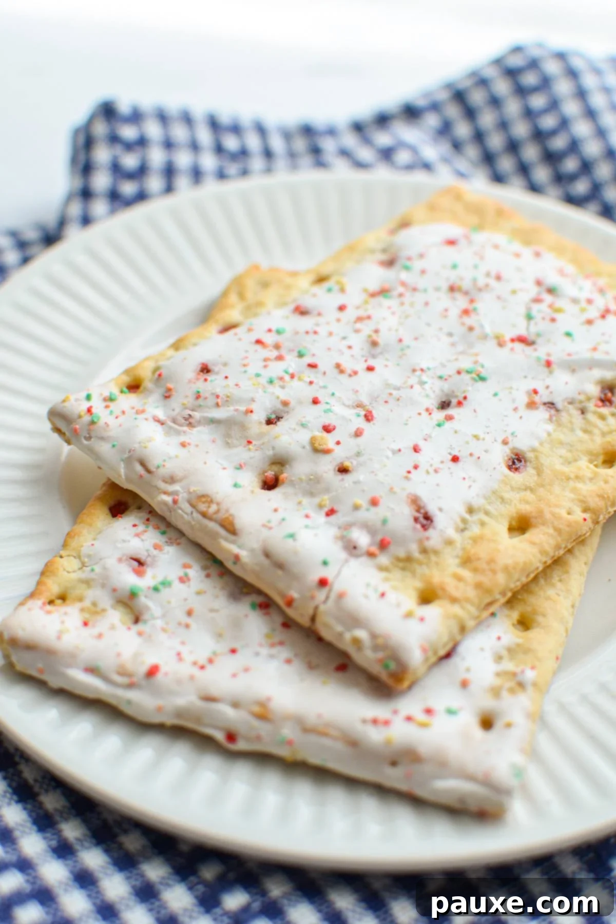 Air Fryer Toaster Pastries 7 A plate with two strawberry pop tarts layered on top.