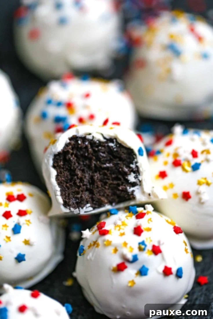 Festive 4th of July Oreo truffles coated in white chocolate and decorated with patriotic sprinkles.