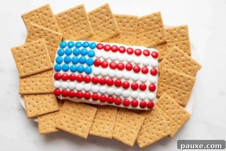 A festive 4th of July cheese ball dessert, creatively shaped and decorated like an American flag.
