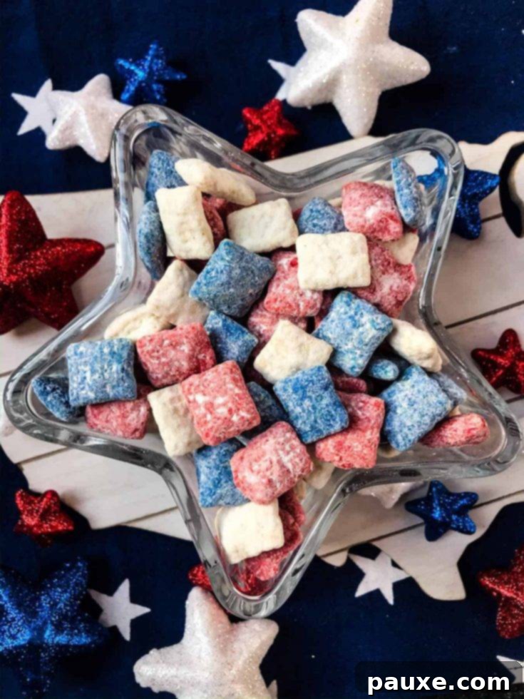 A festive bowl of patriotic red, white, and blue puppy chow, an ideal snack for holiday parties.
