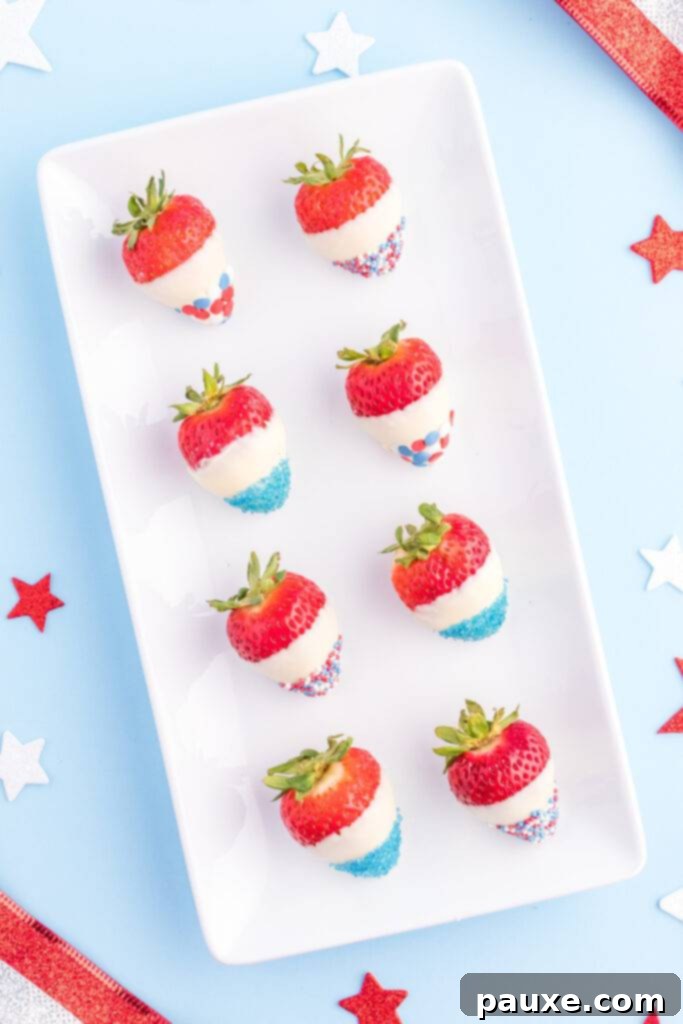 Fresh strawberries dipped in white chocolate and decorated with patriotic red and blue sprinkles.