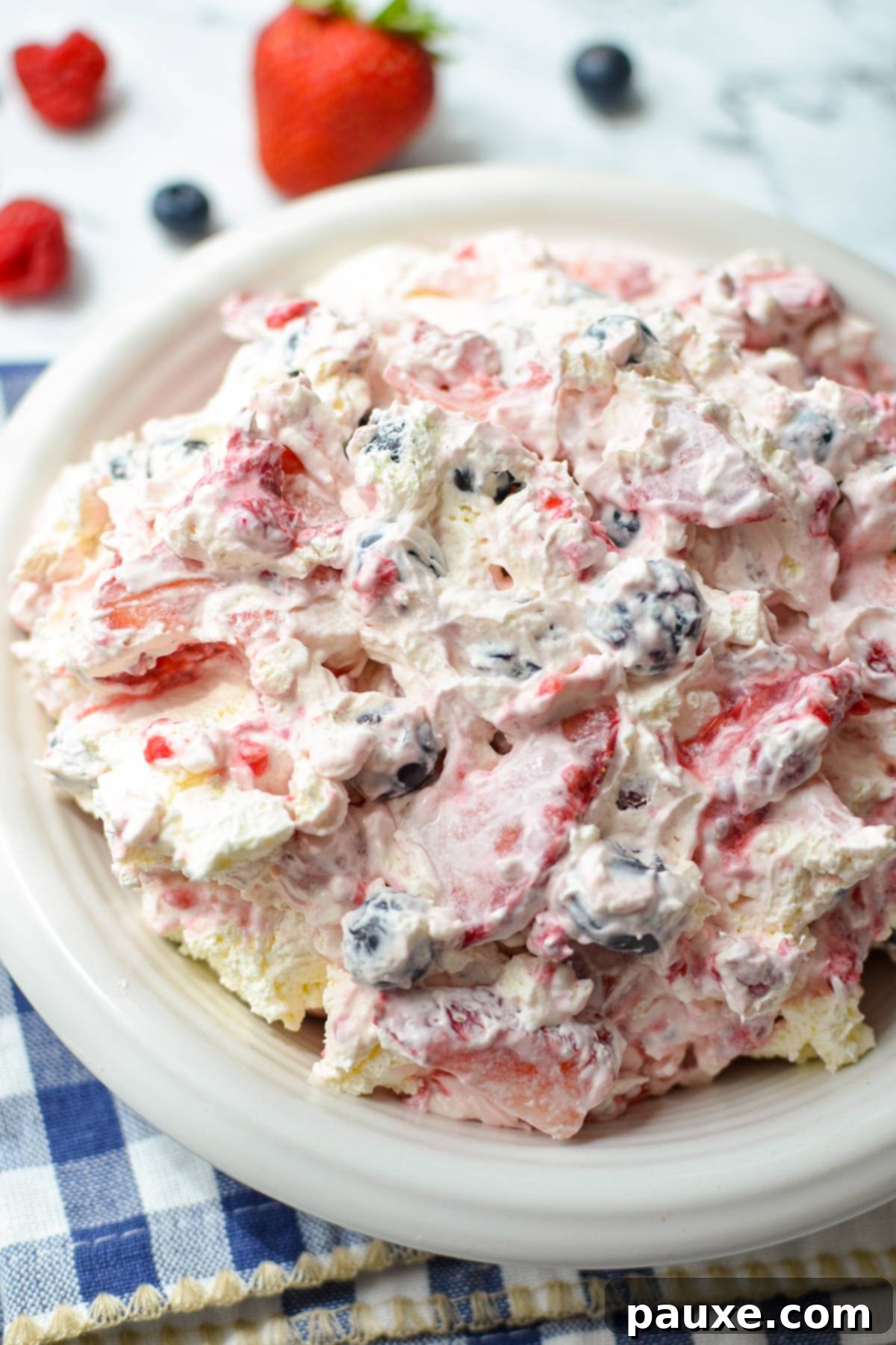 Red, White, and Blue Cheesecake Berry Bliss 9 A bowl of whipped cream based salad with fresh berries.
