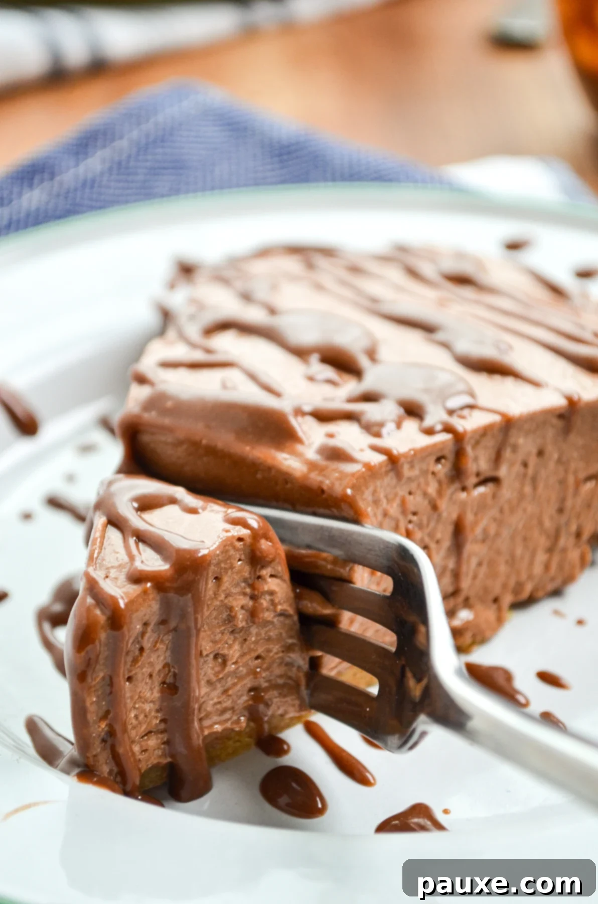 A fork sinking into a creamy slice of No Bake Nutella Pie, showcasing its rich texture and delicious layers.
