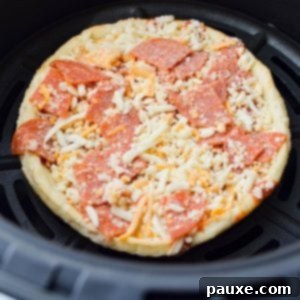 Crispy Air Fryer Frozen Mini Pizzas 8 A close up of a frozen mini pizza showing melted cheese and toppings.