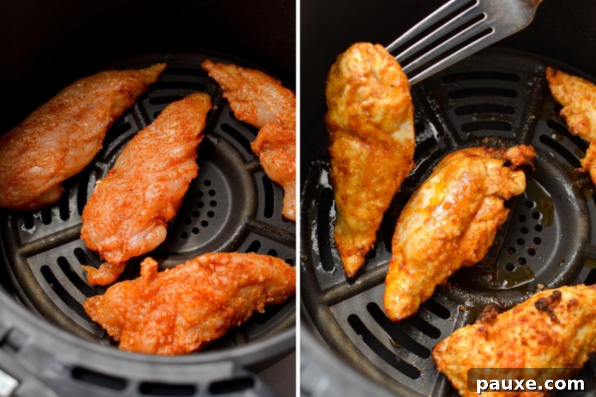 Air Fryer Naked Chicken Tenders 5 Air fryer basket showing several unbreaded chicken tenders cooking, beginning to brown.