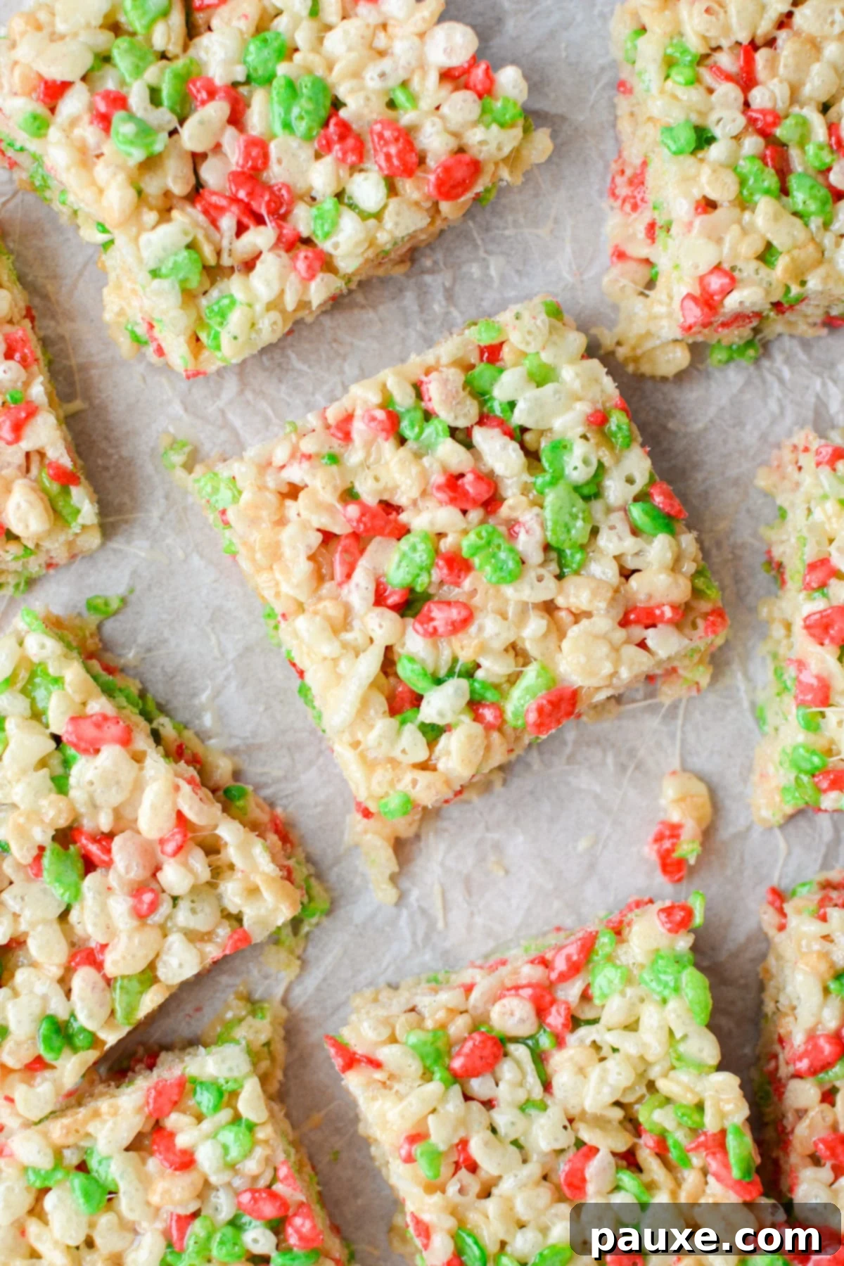 Festive Christmas Rice Krispie Treats 2 An overhead view of holiday Rice Krispie treats on a parchment lined baking sheet.