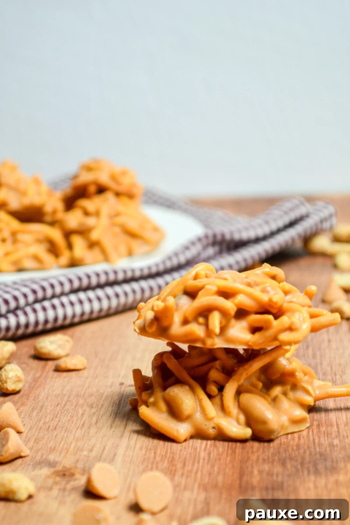 Quick No-Bake Butterscotch Haystacks 7 Two butterscotch haystack cookies, stacked on top of each other, highlighting their texture.