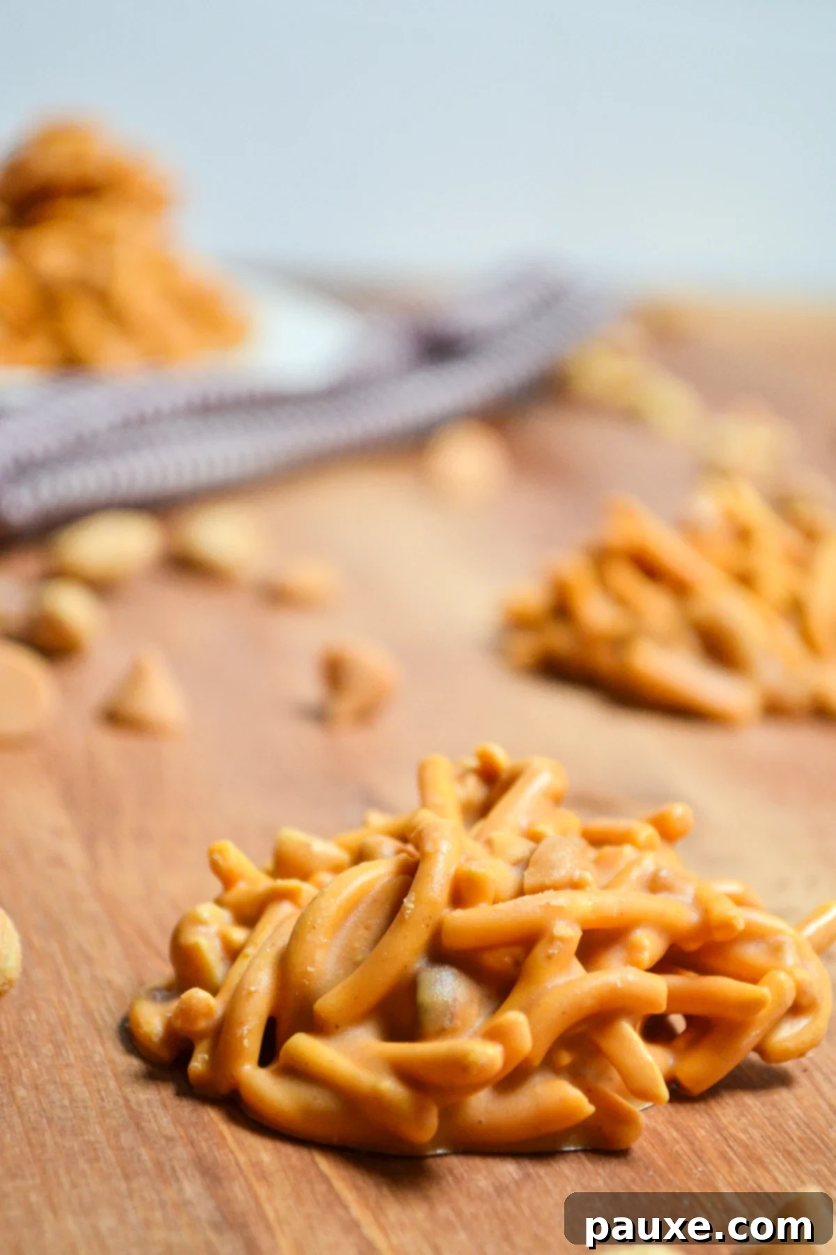 Quick No-Bake Butterscotch Haystacks 8 Butterscotch haystack cookies, artfully arranged on a rustic wooden surface.