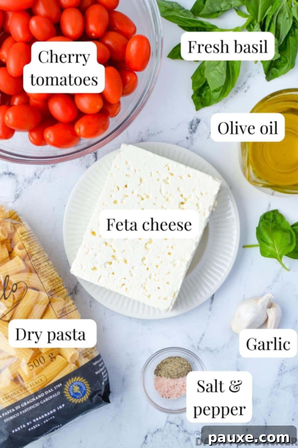 Roasted Tomato and Feta Pasta 3 The ingredients laid out for baked feta pasta: a block of feta cheese, cherry tomatoes, fresh basil, olive oil, and uncooked pasta.