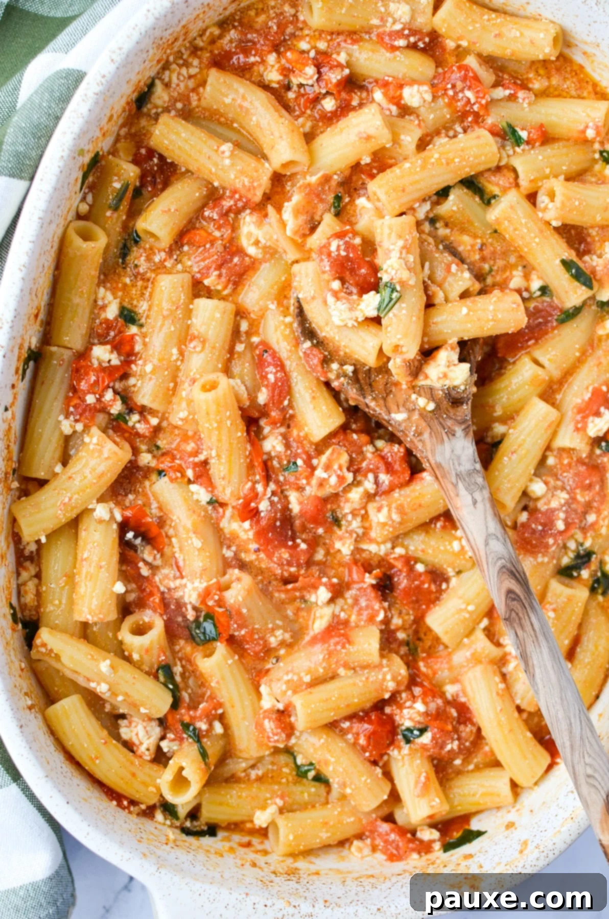 Roasted Tomato and Feta Pasta 7 A baking dish with creamy pasta, roasted tomatoes, feta cheese, and fresh basil ready to be served.