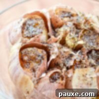 Perfect Air Fryer Roasted Garlic 6 A bulb of garlic, roasted to perfection in the air fryer, showcasing its golden-brown and tender cloves.