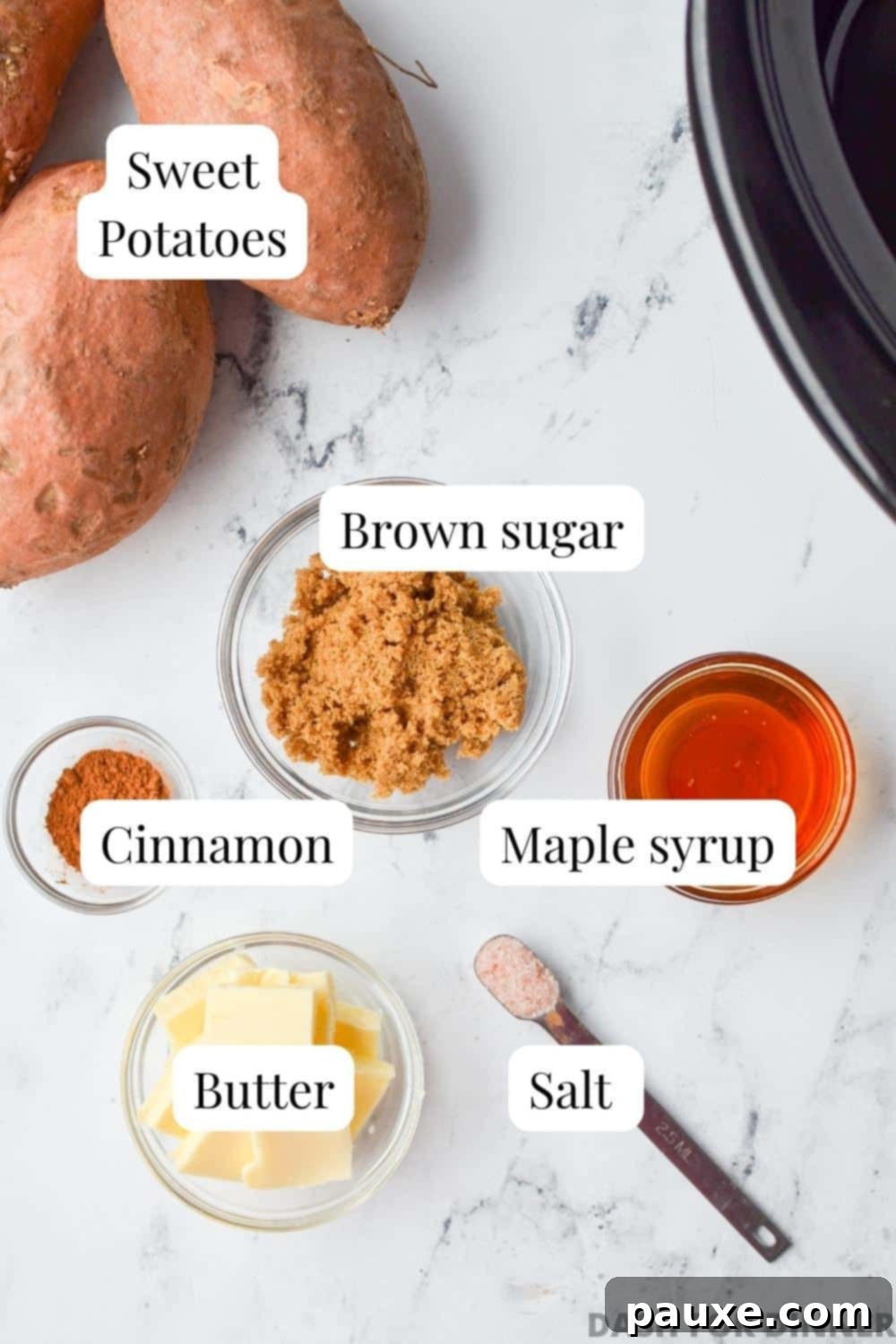 Slow Cooker Candied Sweet Potatoes 3 A flat lay photograph showcasing all the simple ingredients required for slow cooker glazed sweet potatoes: whole sweet potatoes, a bowl of brown sugar, a bottle of maple syrup, a small dish of ground cinnamon, a stick of butter, and a pinch of salt.
