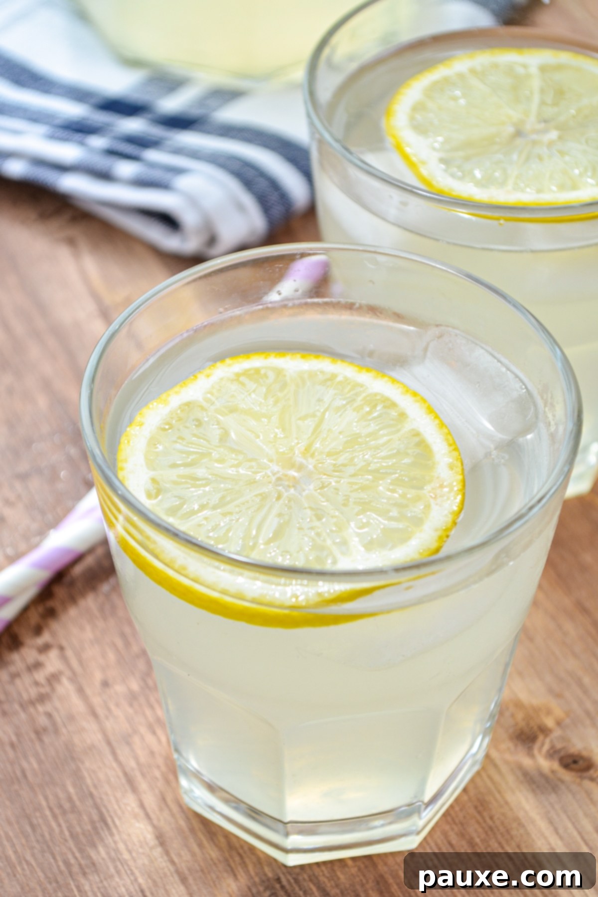 Instant Pot Zesty Lemonade 8 Two glasses of instant pot lemonade, garnished with a lemon slice.