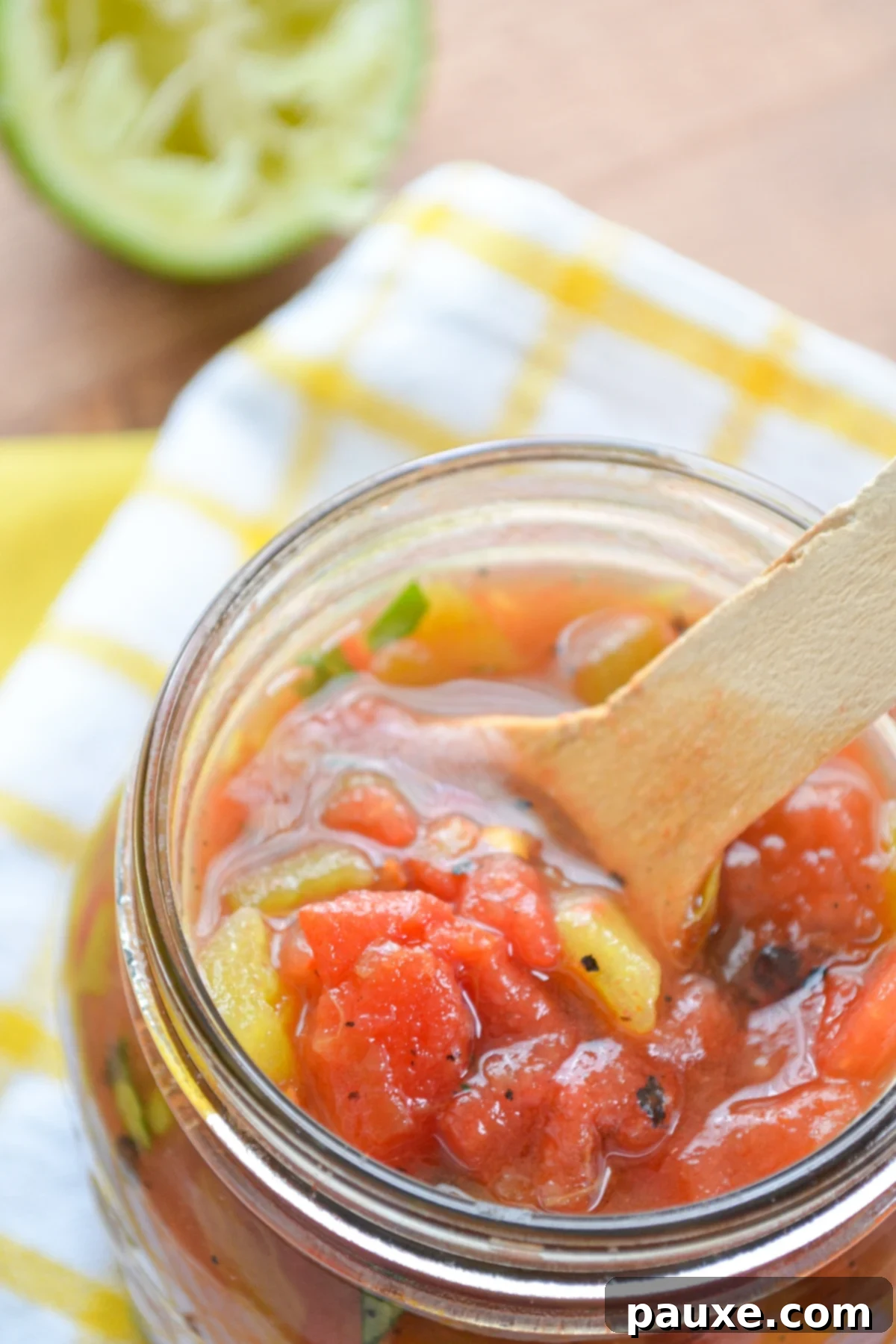 Homemade Rotel-Style Tomatoes and Green Chilies 2 A homemade substitute for Rotel tomatoes and chilies in a glass jar, ready for use.