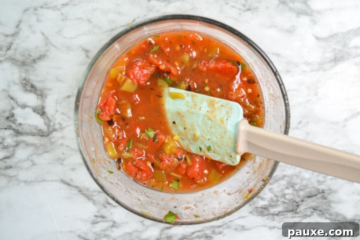 Homemade Rotel-Style Tomatoes and Green Chilies 6 A bowl of freshly mixed diced tomatoes and green chilies, prepared to be used as a delicious Rotel substitute.