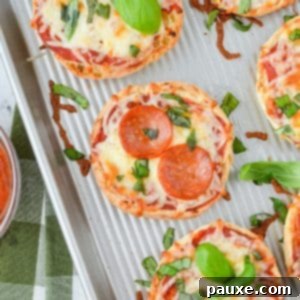 English muffin pizzas on a sheet pan.