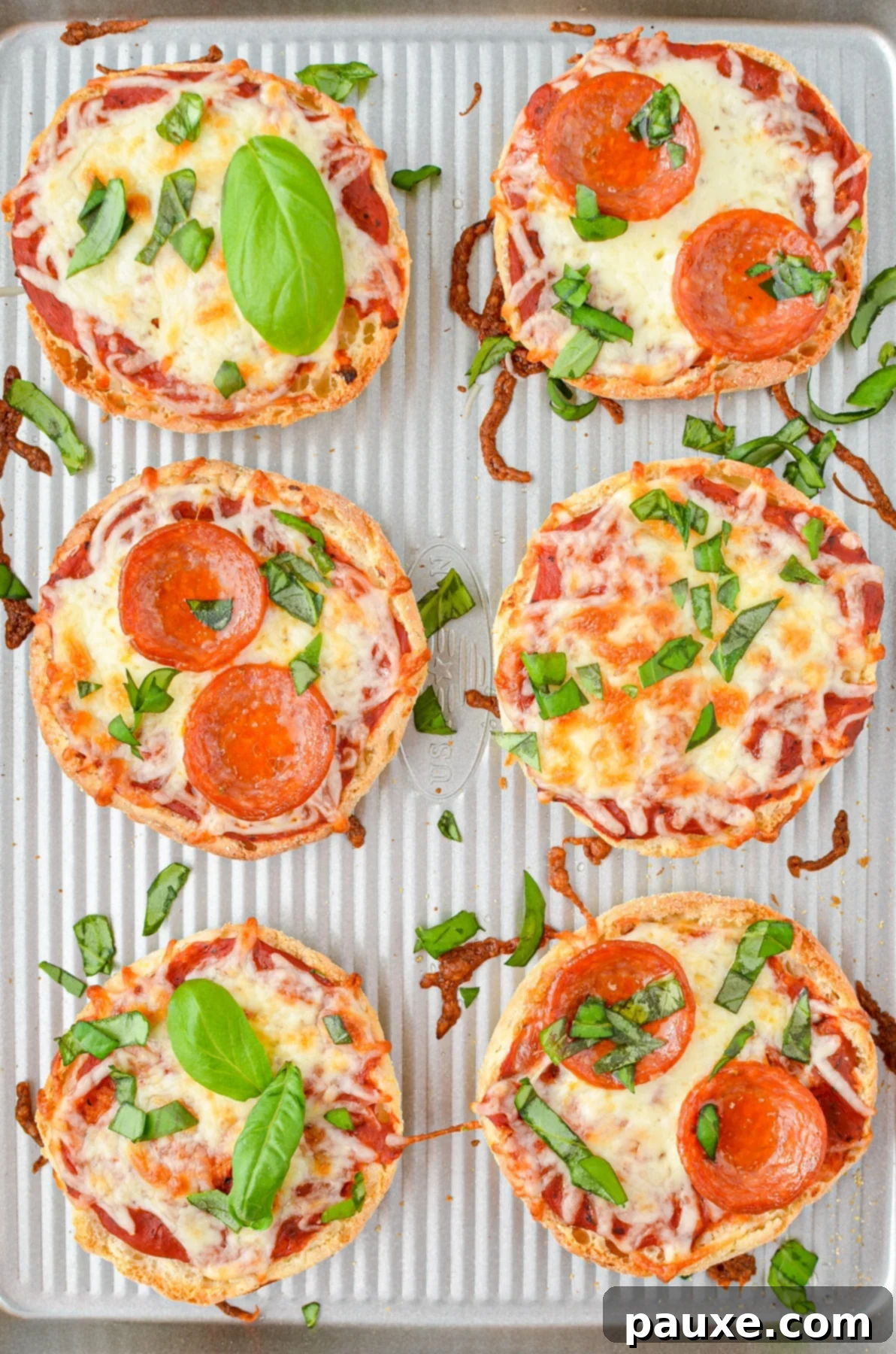 A baking sheet with mini pizzas.