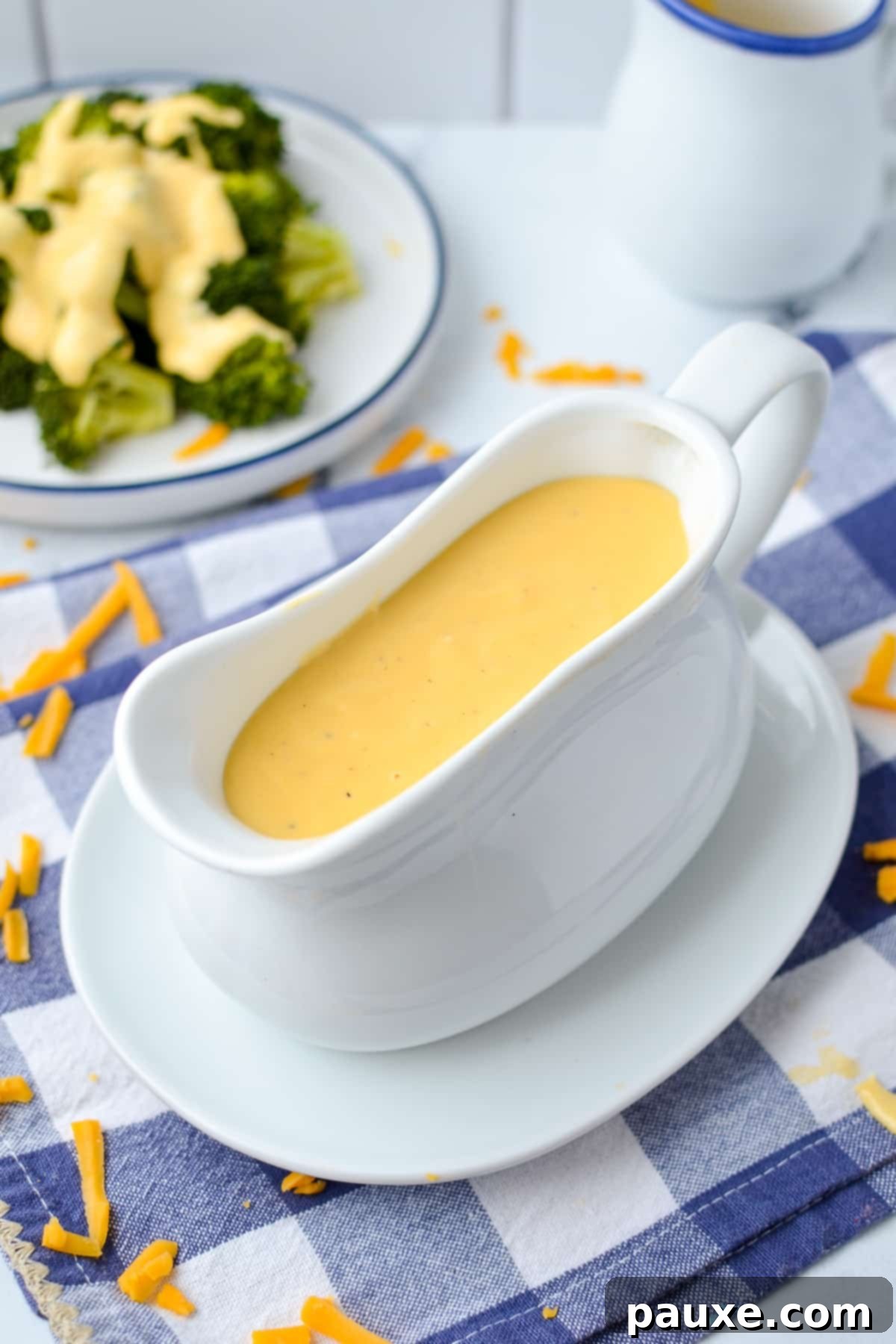 Mom's Legendary Cheese Sauce 2 Cheese sauce in a gravy boat, ready to be served over various dishes.