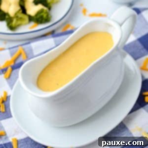 Mom's Legendary Cheese Sauce 12 A gravy boat filled with smooth, golden cheese sauce, ready to be served.