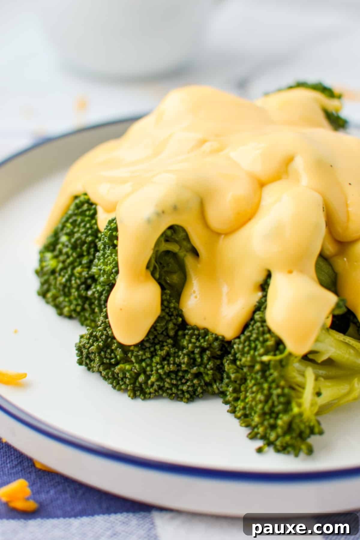 Mom's Legendary Cheese Sauce 3 Creamy cheese sauce generously poured on top of fresh, steamed broccoli florets.
