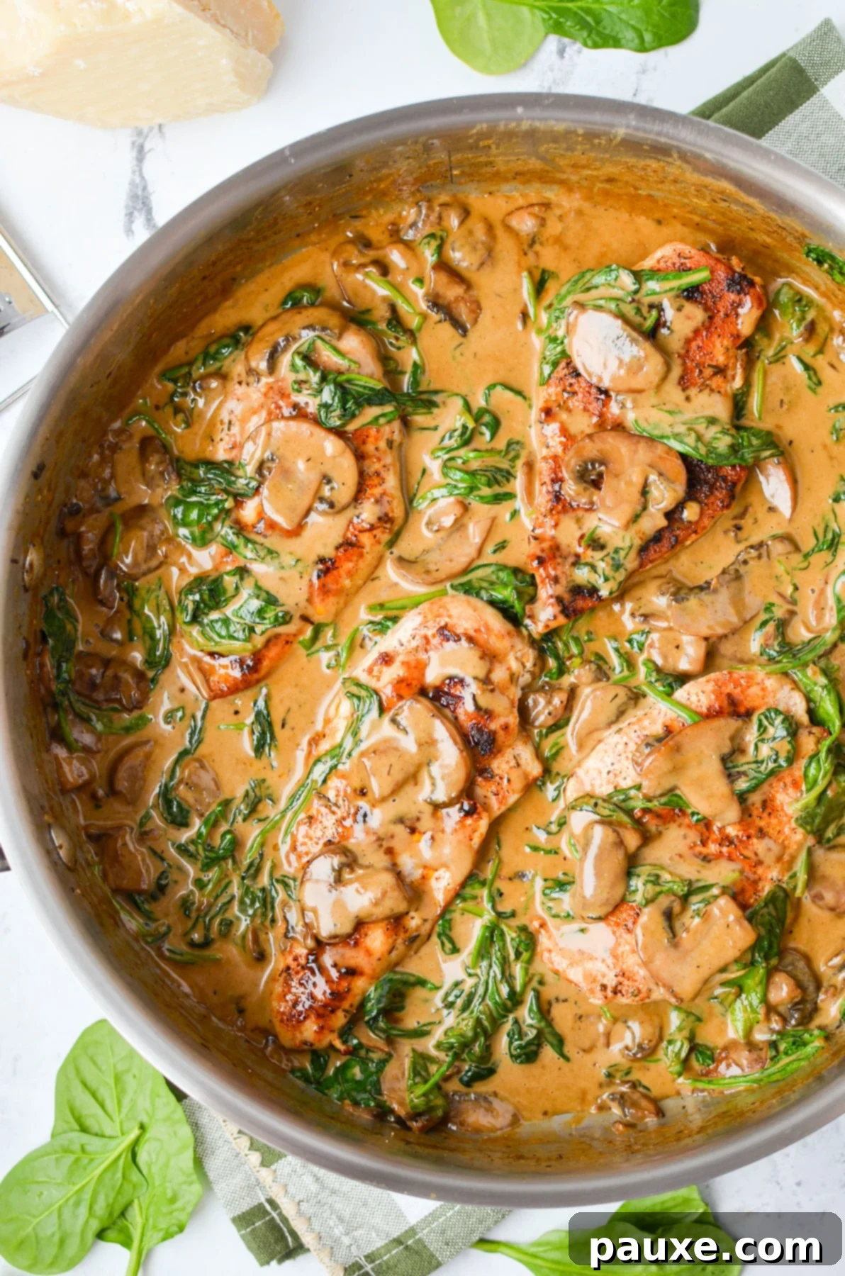 Creamy Mushroom and Spinach Chicken Delight 2 A skillet filled with beautifully cooked chicken covered in a luscious spinach and mushroom cream sauce, ready to serve.