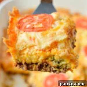 The Duke's Hearty Casserole 12 Lifting a square of cheesy John Wayne Casserole from a baking dish, showcasing its perfect layers for a delicious meal.