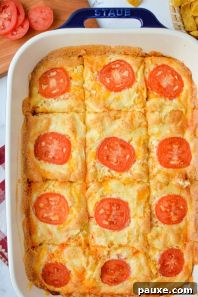 The Duke's Hearty Casserole 9 A baking dish displaying neatly cut sections of hearty egg and cheese casserole, ready to be served for a satisfying meal.