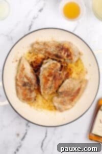 Chicken breasts that have been browned in a skillet.