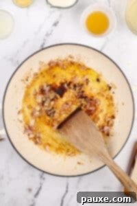 Cooking a shallot in a skillet with oil and butter.