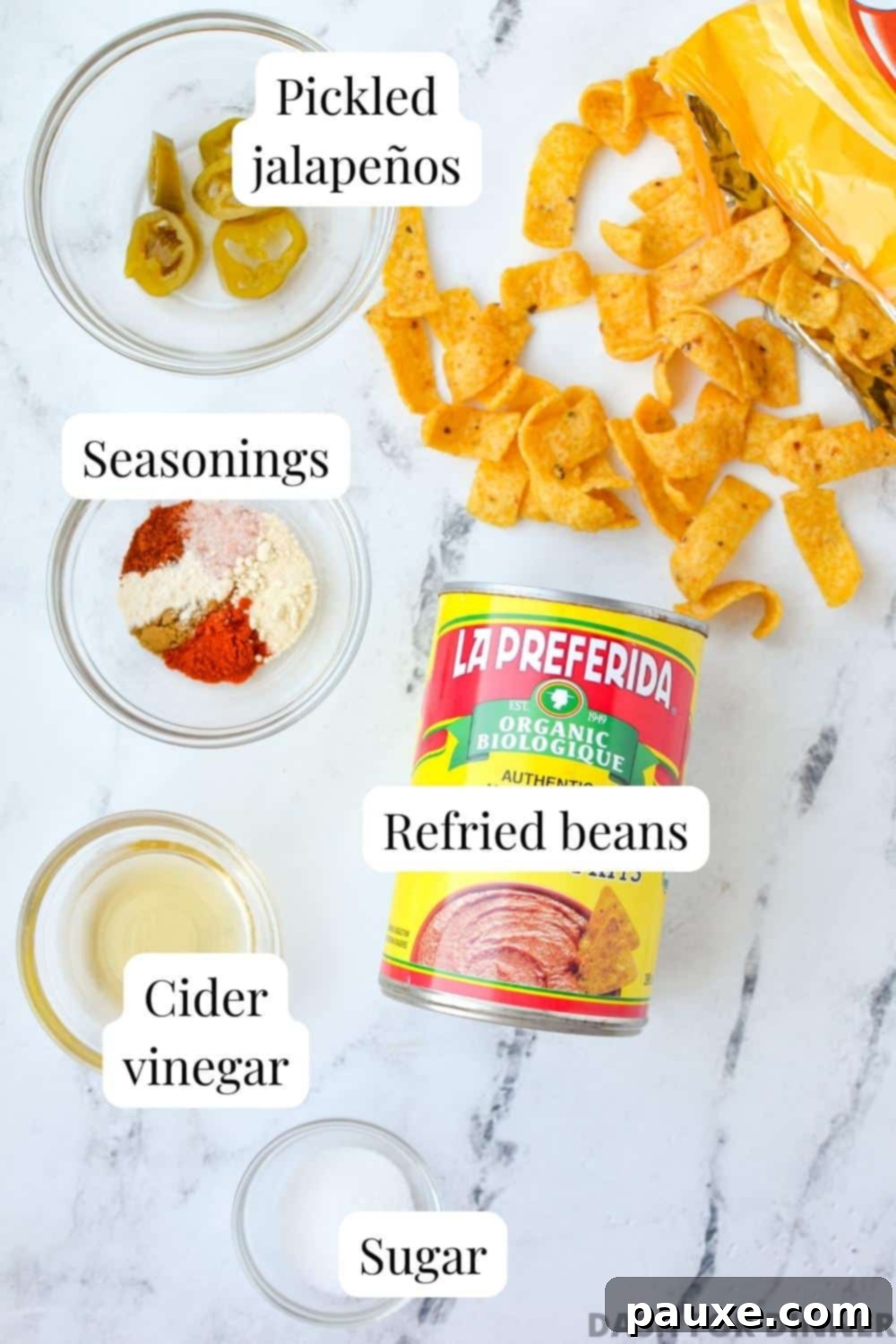 Craveable Homemade Fritos Bean Dip 3 The ingredients needed to make bean dip: refried beans, seasoning, cider vinegar, sugar, and jalapeno slices.