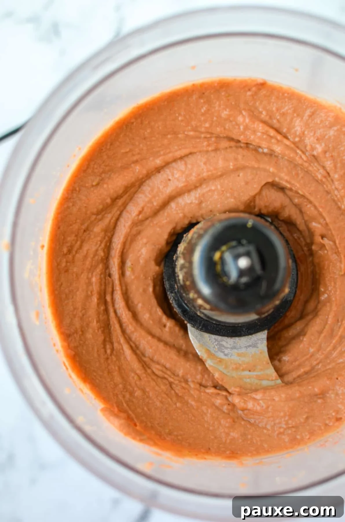 Craveable Homemade Fritos Bean Dip 5 A food processor with blended bean dip.