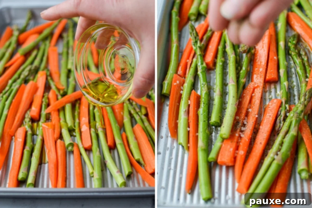 Garlic Herb Roasted Asparagus and Carrots 4 Drizzling olive oil on a sheet pan of roasted asparagus and carrots before seasoning.