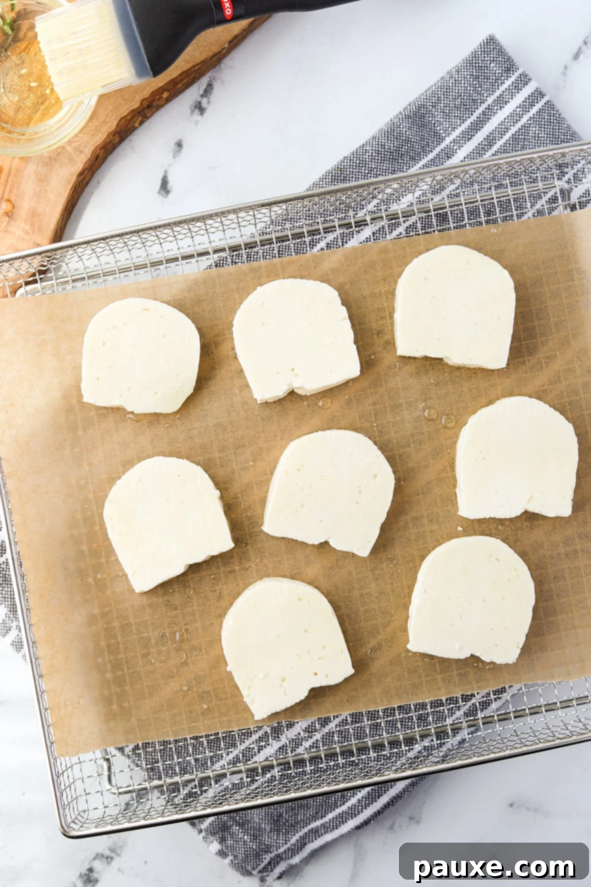 Golden Air Fryer Halloumi 5 An air fryer tray neatly arranged with Halloumi cheese slices in a single layer, ready for cooking.