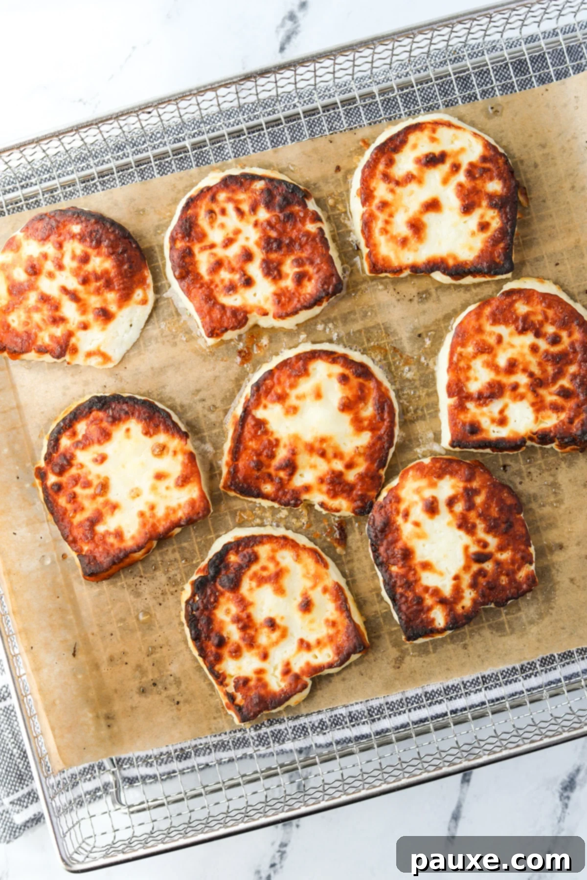 Golden Air Fryer Halloumi 6 Perfectly air-fried Halloumi slices, golden and crispy, removed from the air fryer.