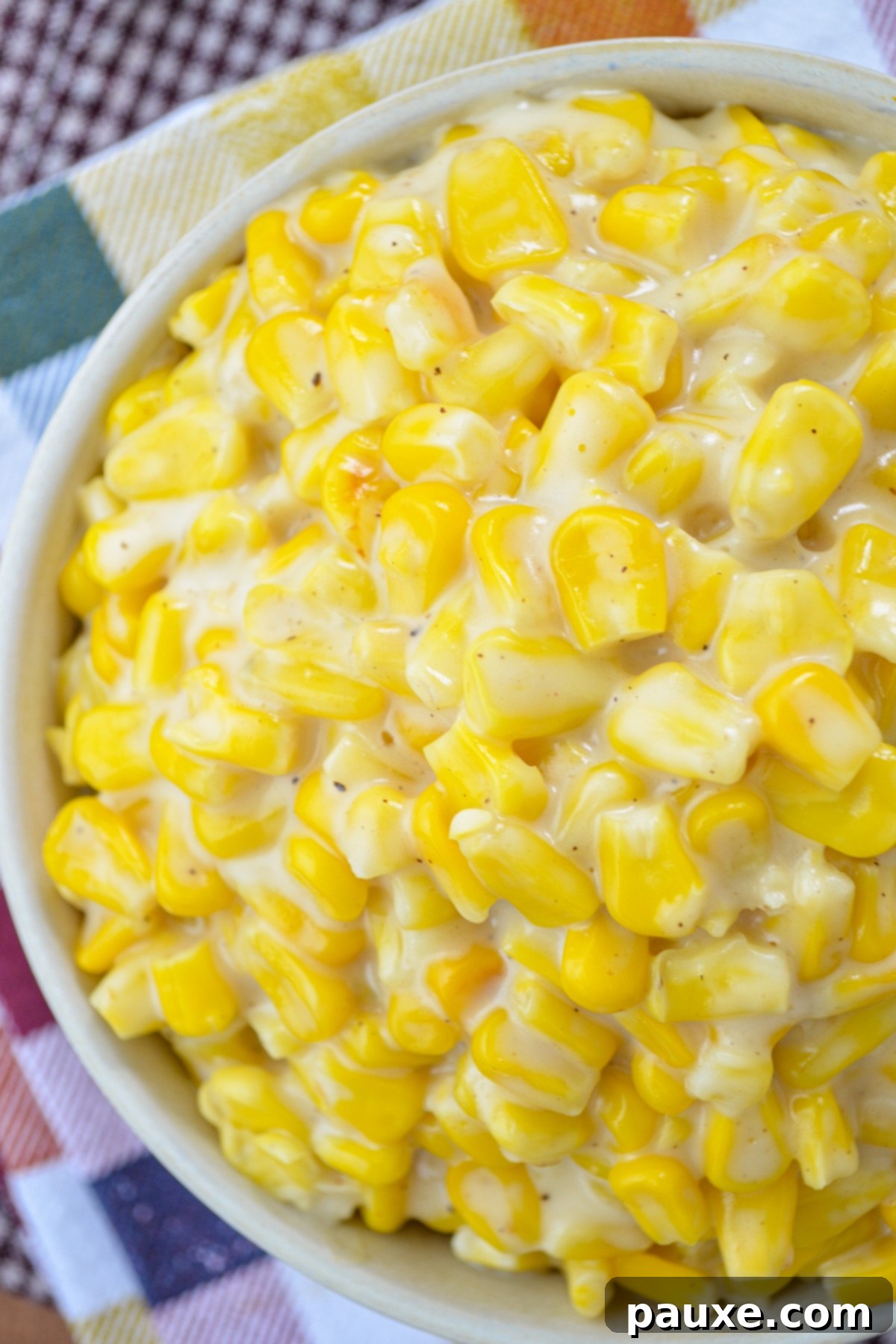 A close up of a bowl of creamed corn.