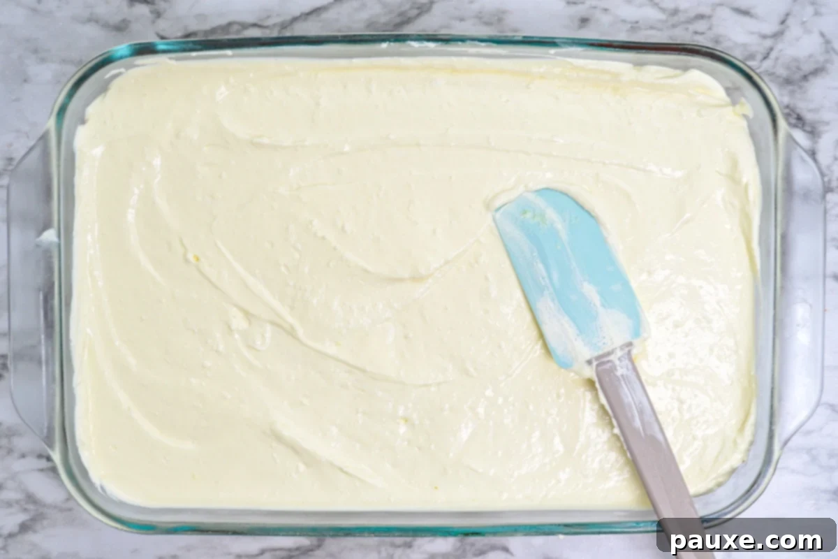 Spooky Layered Gelatin 9 The creamy cheesecake Jell-O layer spread smoothly over the orange layer in a glass dish.