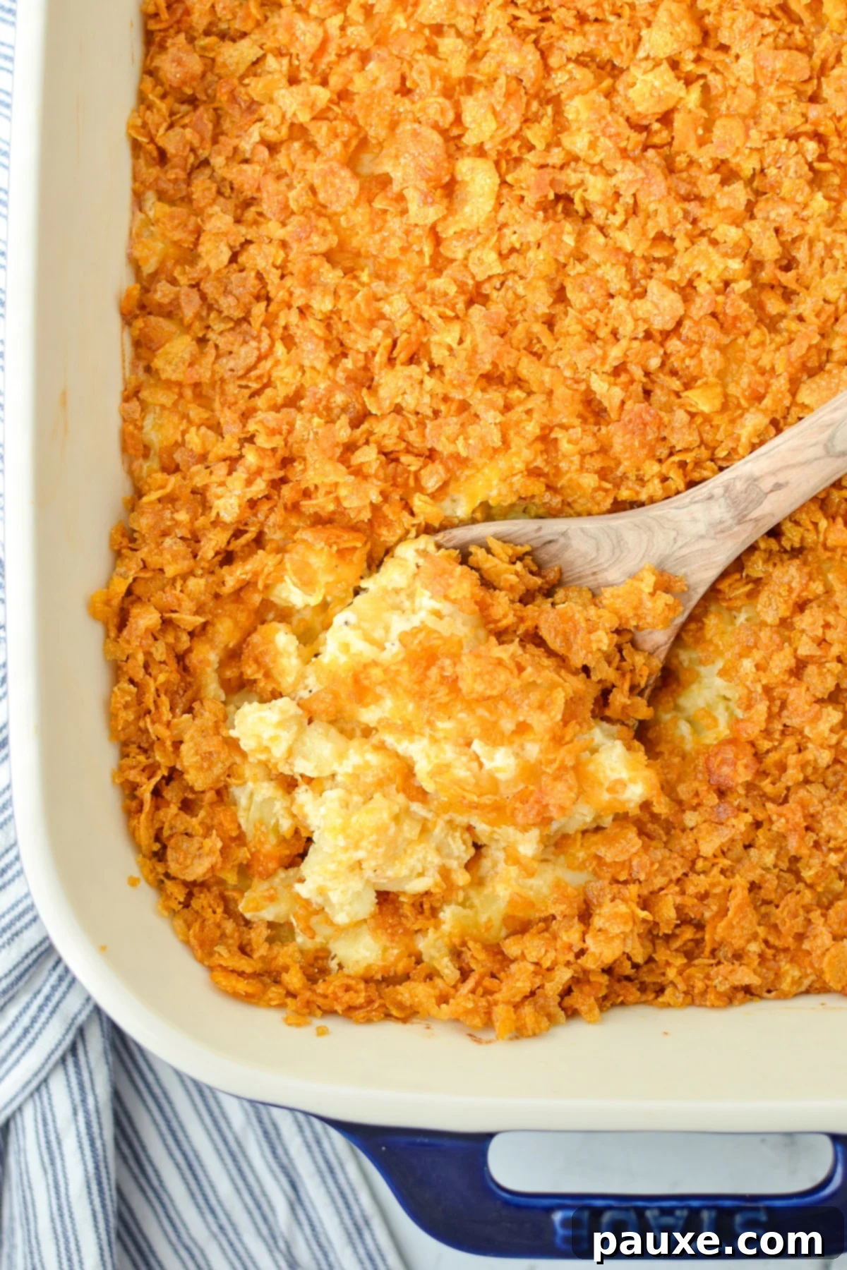 Effortless Cheesy Funeral Potatoes 7 A baking dish with hash brown casserole in it.