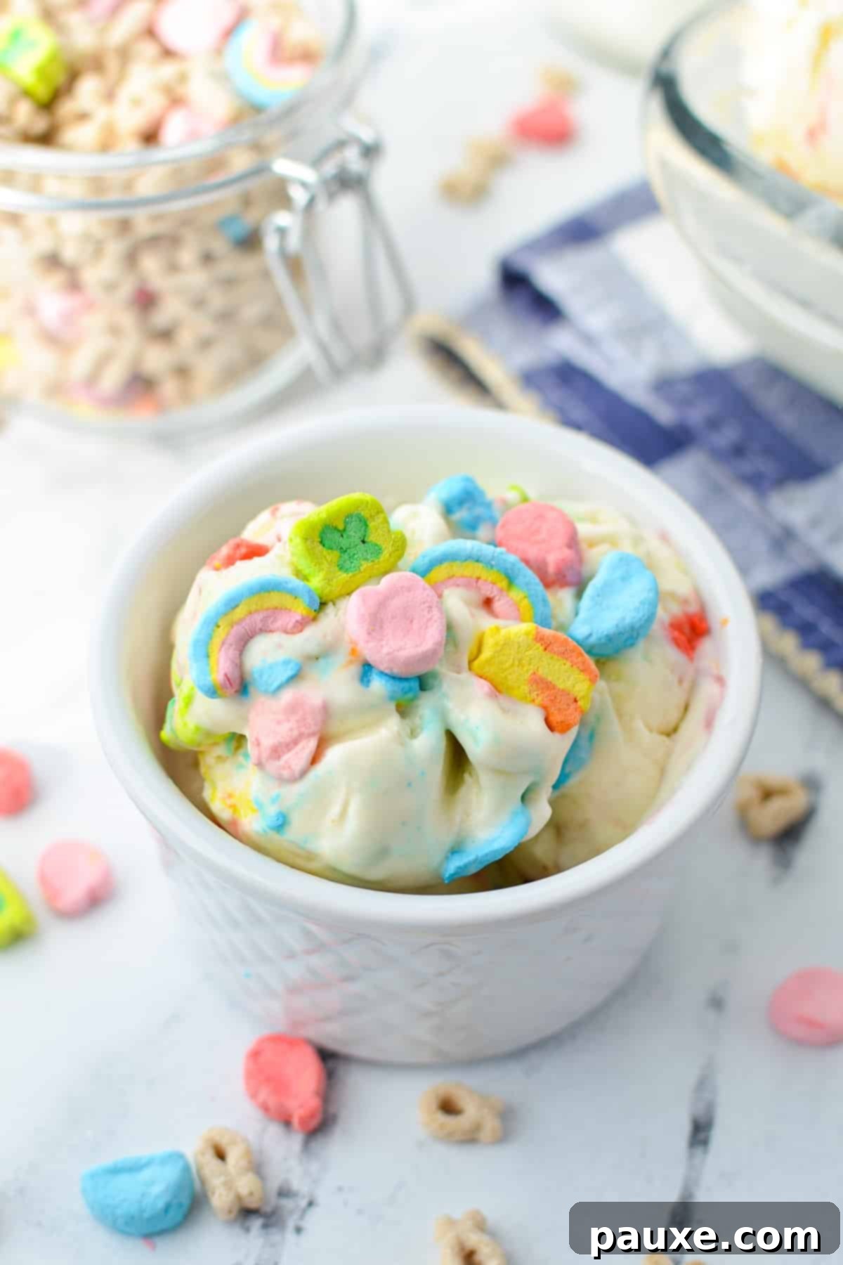 Enchanted Cereal Swirl 2 A small bowl of creamy, homemade Lucky Charms ice cream, generously dotted with colorful marshmallows and a spoon ready for tasting.