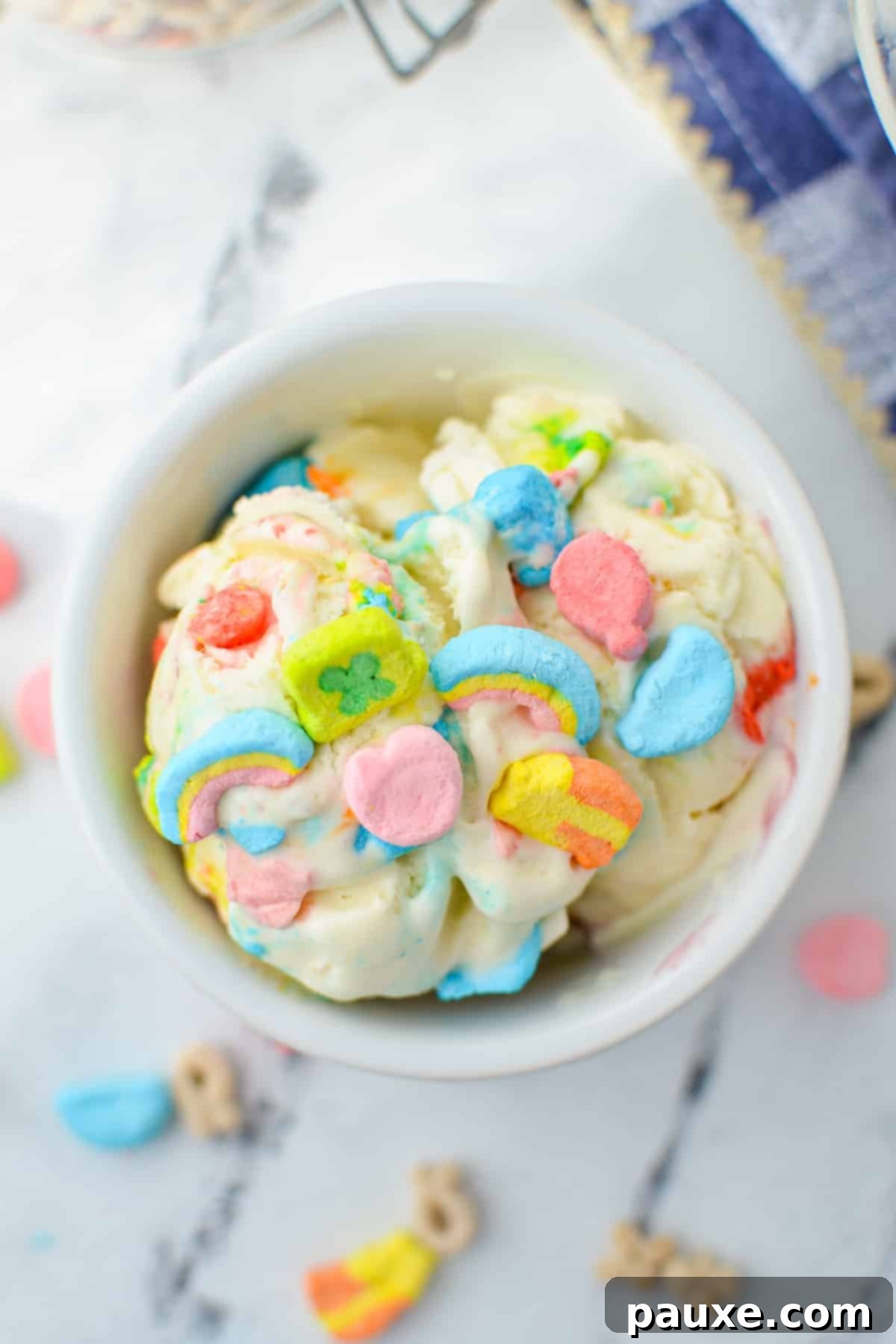 Enchanted Cereal Swirl 7 An overhead view of a small bowl of homemade Lucky Charms ice cream, showcasing its creamy texture and colorful marshmallow inclusions.