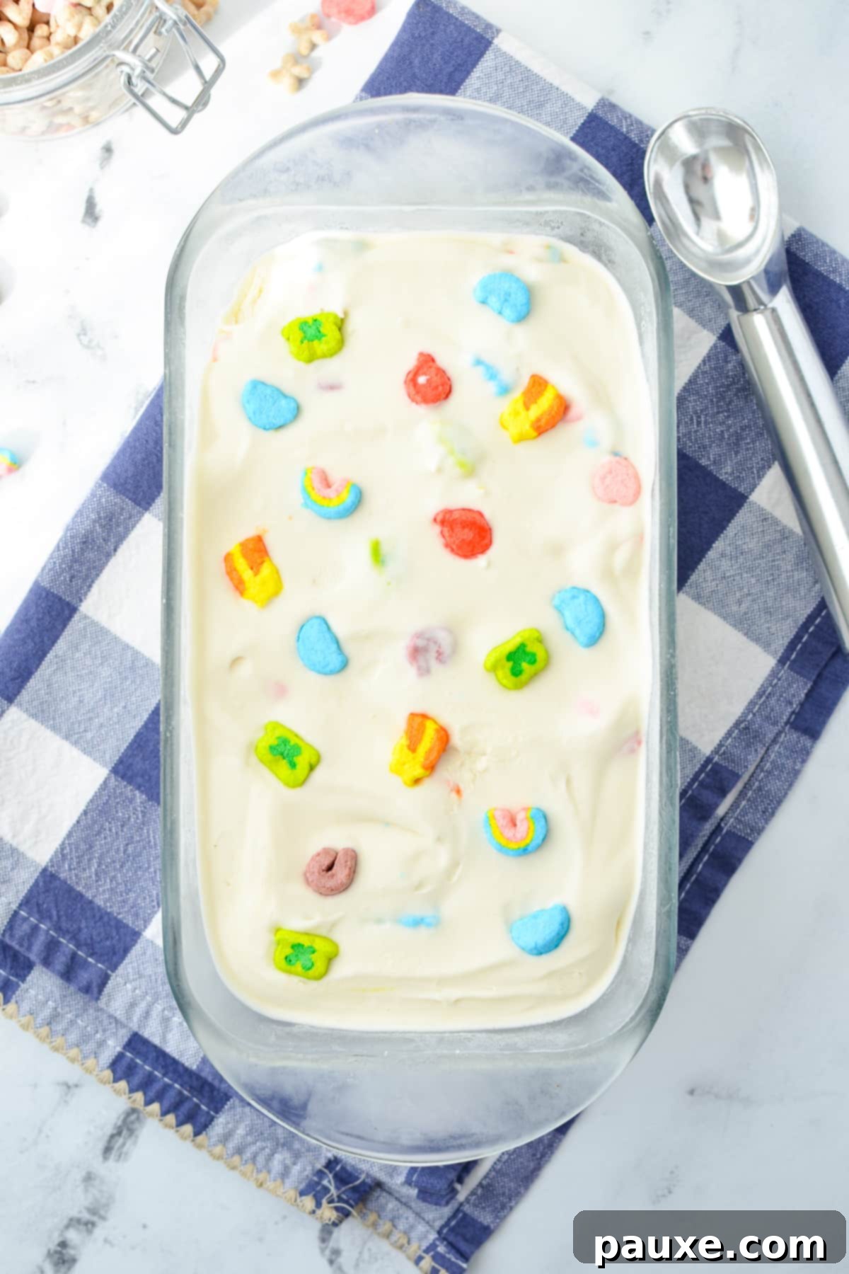 Enchanted Cereal Swirl 8 A loaf pan brimming with freshly made Lucky Charms ice cream, prior to freezing, showing the distribution of colorful marshmallows.