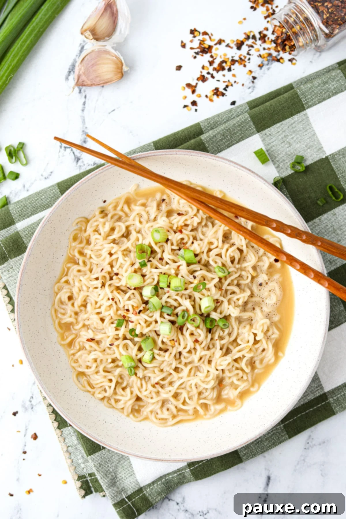 Kylie Jenner's Famous Ramen Hack 7 A warm bowl of Kylie Jenner ramen, served with elegant chopsticks resting on the side, inviting you to enjoy.