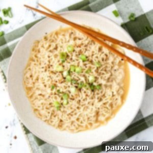 Kylie Jenner's Famous Ramen Hack 9 An overhead shot of a bowl of ramen, garnished with green onions and served with chopsticks.