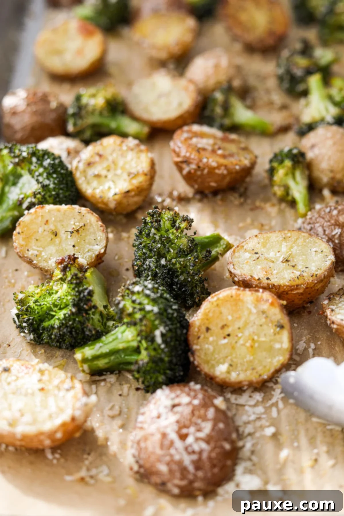 Golden Roasted Broccoli and Potatoes 9 A close up of roasted broccoli with halved baby potatoes.
