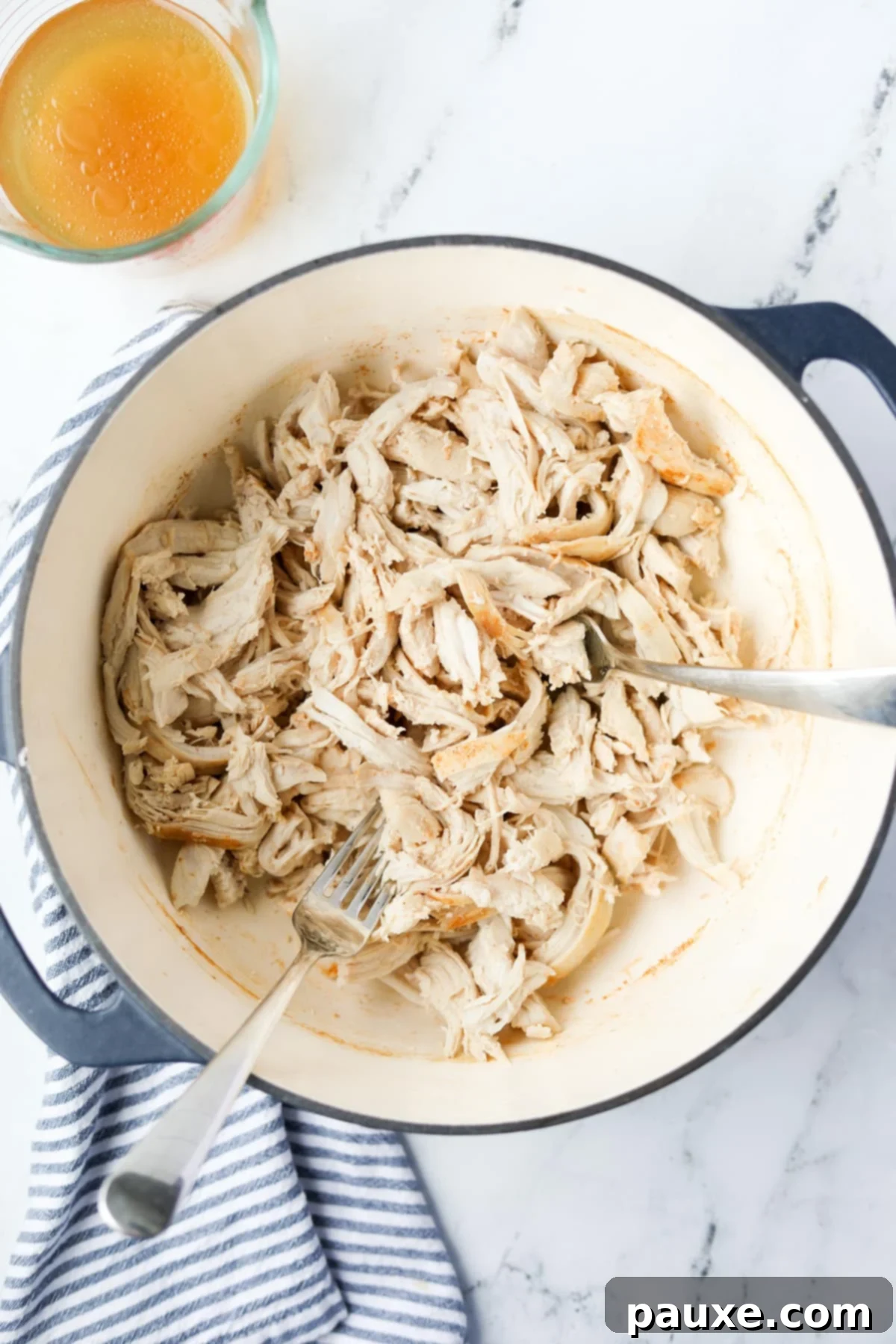 Ultimate Dutch Oven Pulled Chicken 8 A Dutch Oven filled with freshly shredded chicken, ready for a meal.