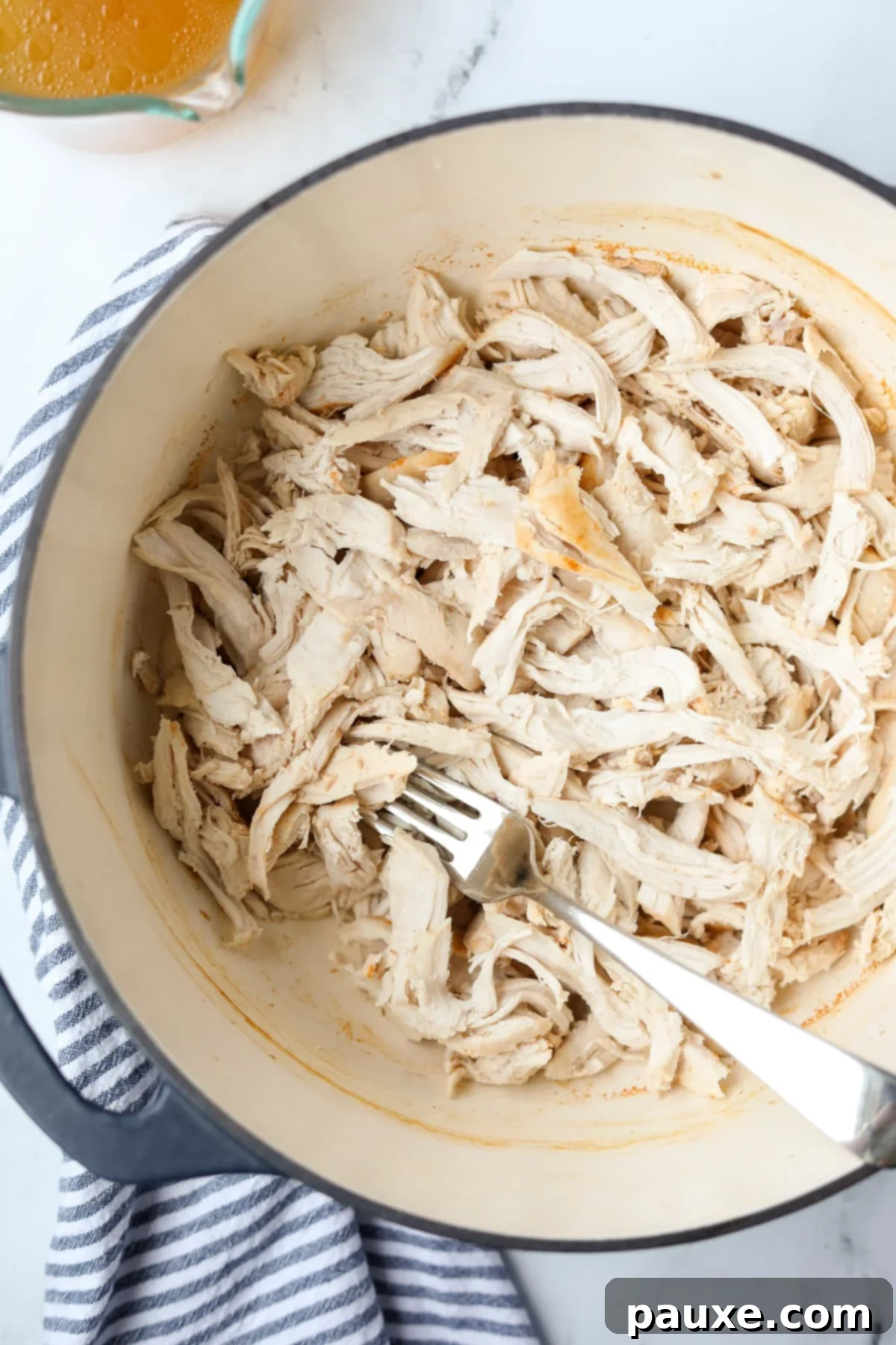 Ultimate Dutch Oven Pulled Chicken 10 A large pot filled to the brim with perfectly cooked and shredded chicken.