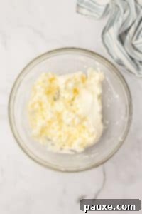 Zesty Slow Cooker Buffalo Chicken Dip 17 A bowl with softened cream cheese.